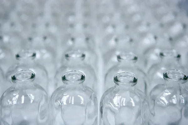 Glass transparent empty bottles assembly line — Stock Photo, Image