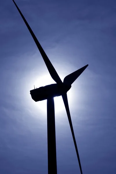 Aerogenerator windmill backlight blue sky — Stock Photo, Image
