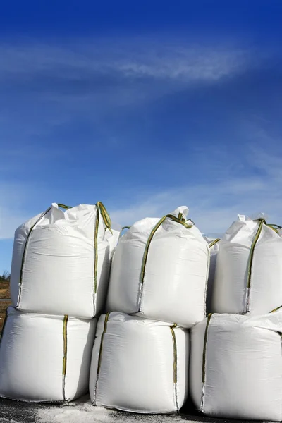 Salt white sacks rows stacked to road ice — Stock Photo, Image