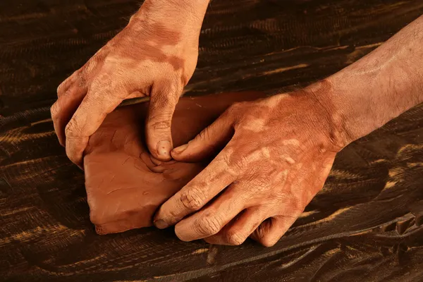 Artist man hands working red clay for handcraft — Stockfoto