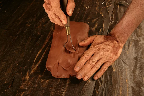 Artist man hands working red clay for handcraft — Stok fotoğraf