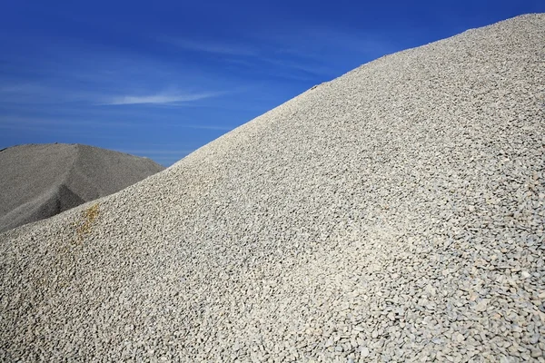 Gravel gray mound quarry stock blue sky — Stock Photo, Image