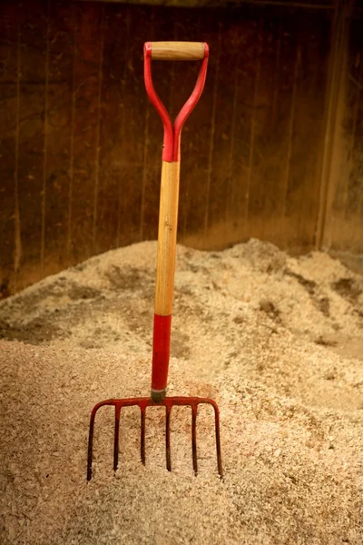 Horse stable witth straw fork tool, sawdust. — Stock Photo, Image
