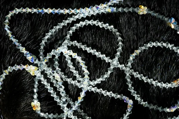 Necklaces over black animal skin background — Stock Photo, Image