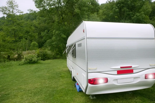 Caravan van in the green meadow camping — Stock Photo, Image