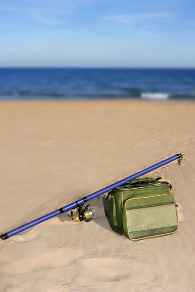 Fishing surfcasting rod and box over beach sand — Stock Photo, Image