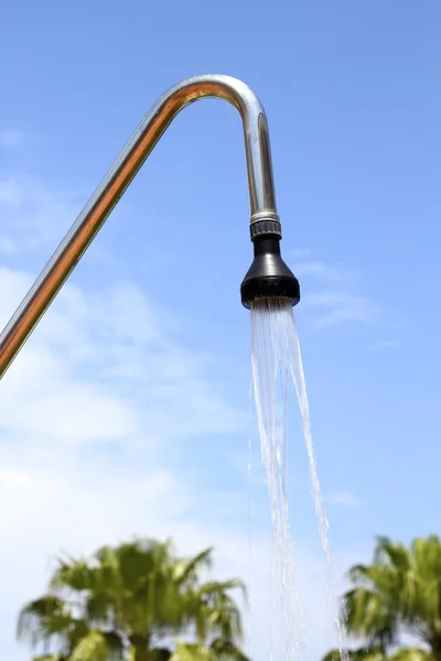 Shower sprinkler on blue sky outdoor water falling — Stock Photo, Image