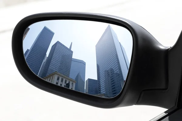 Rearview car driving mirror view city downtown — Stock Photo, Image