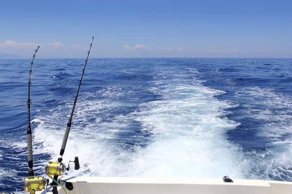 Blue sea fishing sunny day trolling rod reels wake — Stock Photo, Image