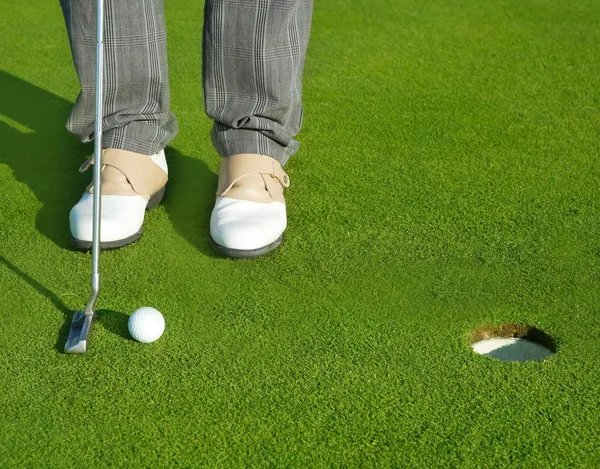 Golf homem curso buraco verde colocando bola curta — Fotografia de Stock