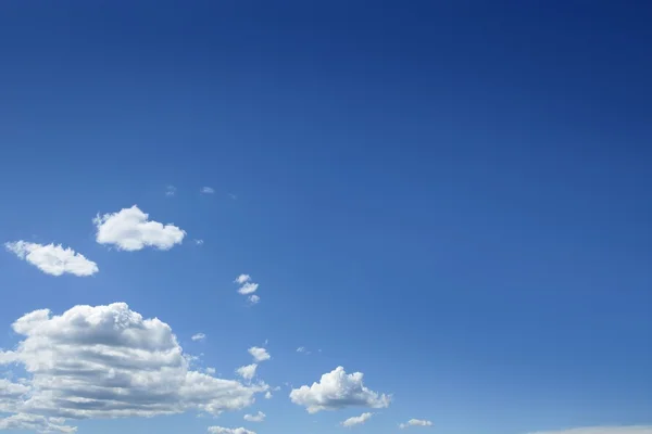Blauwe mooie hemel met witte wolken in zonnige dag — Stockfoto