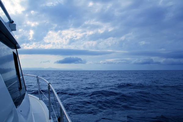 Boat sailing in cloudy stormy day blue ocean — Stock Photo, Image