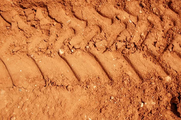 Clay red soil with tractor tires footprint — Stock Photo, Image