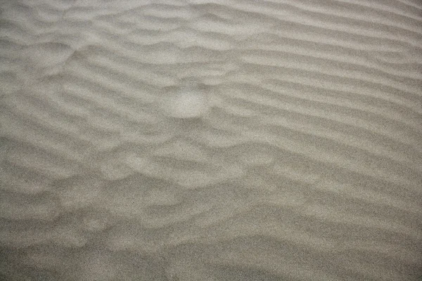 Playa arena olas textura cálida fondo — Foto de Stock