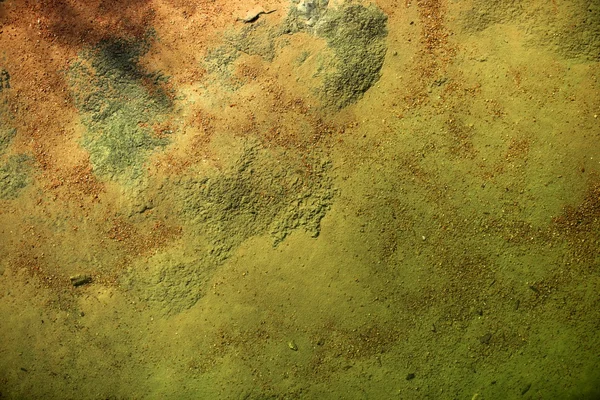 Нижня частина текстури річки, помаранчевий і зелений фон — стокове фото
