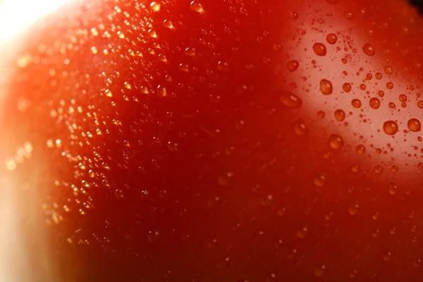 Red tomato macro over green background — Stock Photo, Image