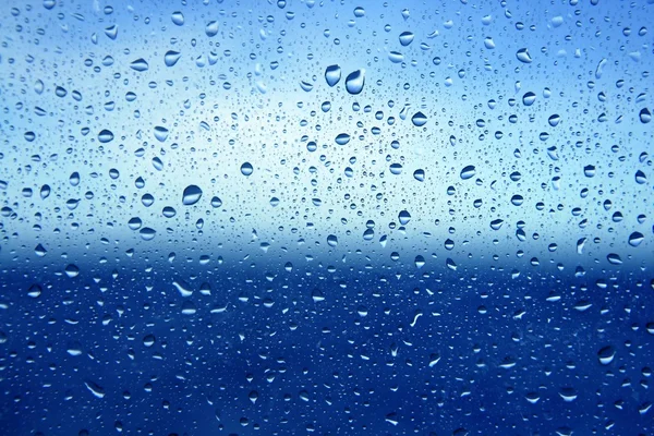 Absztrakt kék víz dropsoin üveg háttér — Stock Fotó