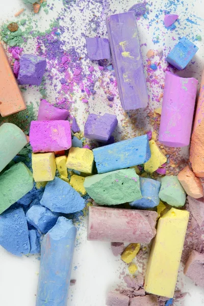 Colorful chalk broken colors mess over white — Stock Photo, Image