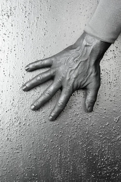 Hombre futurista plata mano sobre acero texturizado —  Fotos de Stock