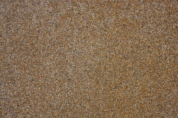 Praia areia molhada textura marrom mediterrâneo — Fotografia de Stock