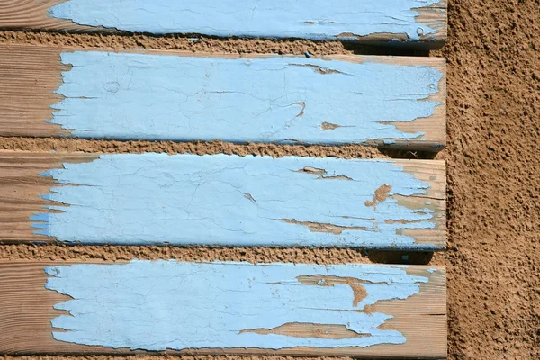 Aged beach blue wooden floor on sand — Stock Photo, Image