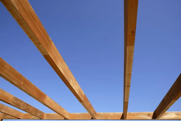 Blue sky wooden golden awning beams — Stock Photo, Image