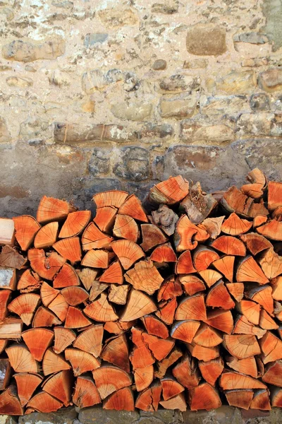Firewood wood pile stacked triangle shape — Stock Photo, Image