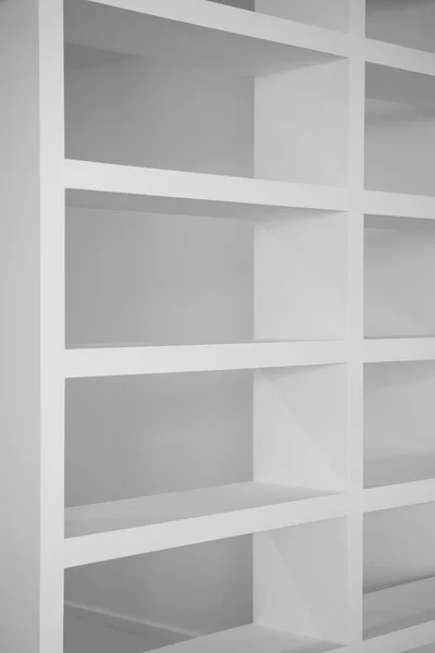 Bookshelf in white empty blank shelfs — Stok fotoğraf