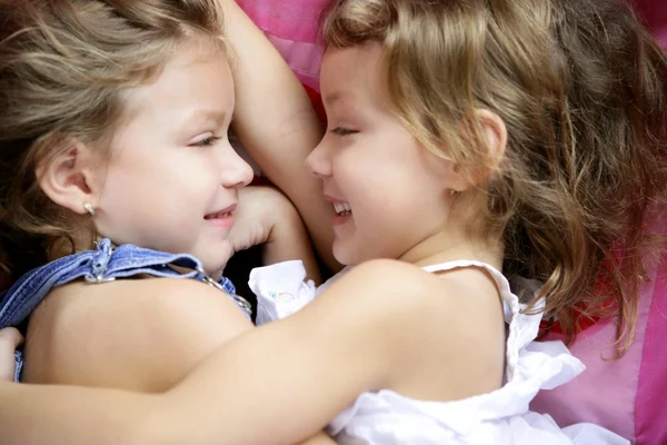 Two twin sisters in a hug, close up Royalty Free Stock Images