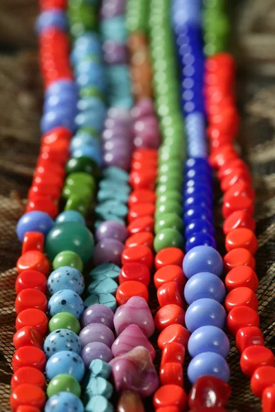 Color stones jewelry necklaces, straw background Stock Photo