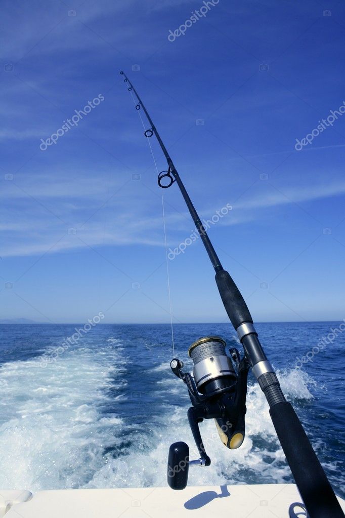 Fishing rod and reel on boat, fishing in blue ocean Stock Photo by  ©lunamarina 5505736