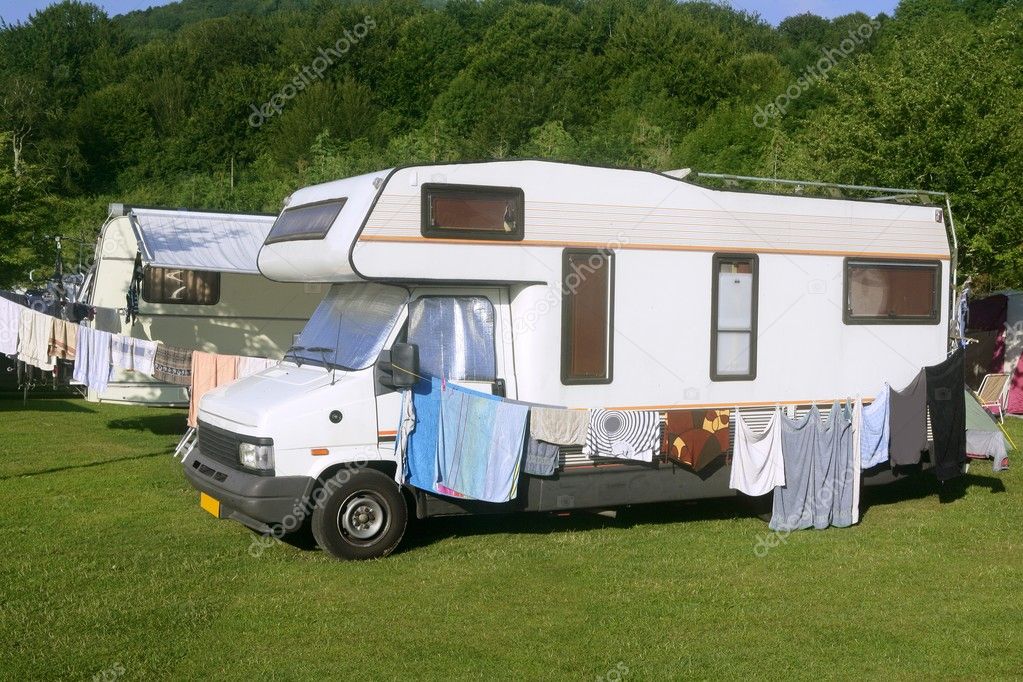 Caravan van in the green meadow camping