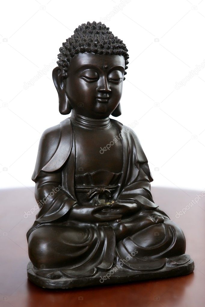 Buddha little black sculpture over red wood