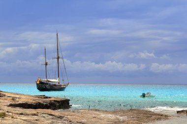 Pirates inspired wood sailboat anchored turquoise clipart