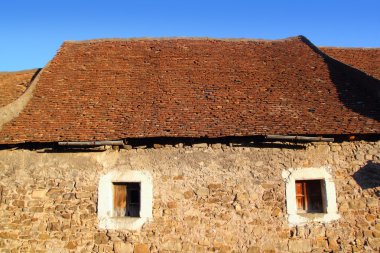 Square clay roof tiles house in Pyrenees Spain clipart