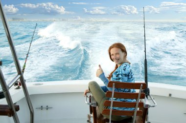 Fisherwoman big game on boat chair ok sign