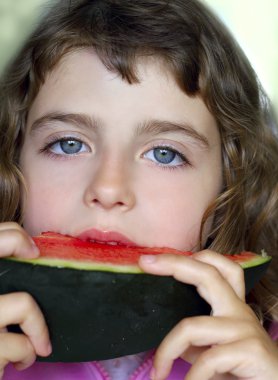 Closeup little girl portrait eating watermelon slice clipart