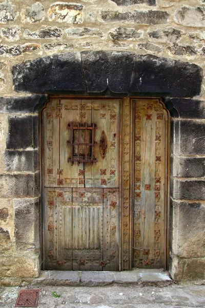 Porta de madeira medieval na parede de pedra Pirinéus — Fotografia de Stock