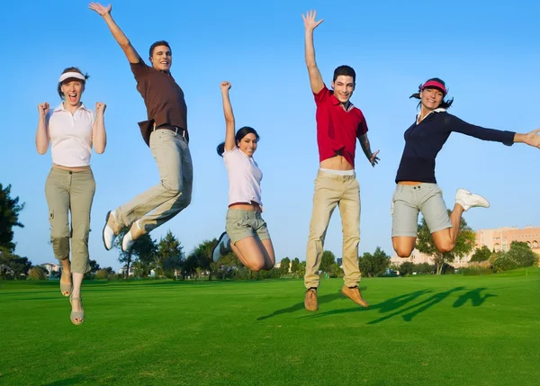 Group of young jumping outdoors grass — Stock Photo, Image