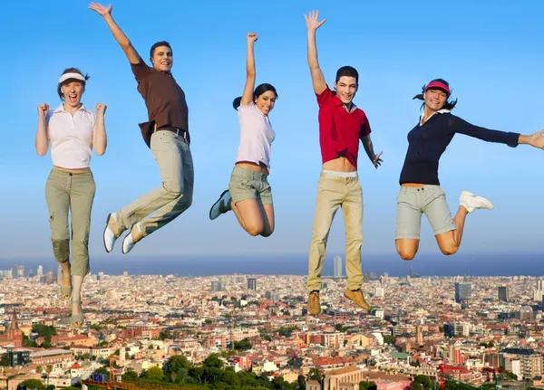 Jumping young group on city buildings — Stock Photo, Image