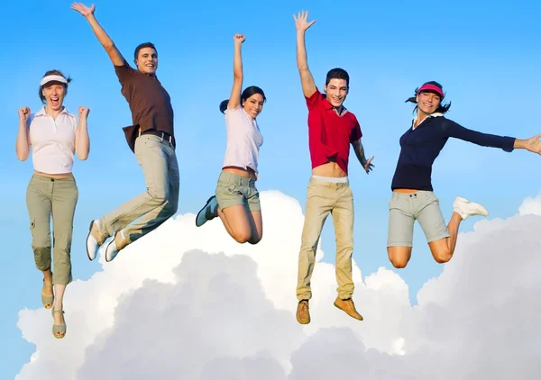 Jumping young happy group flying in sky — Stock Photo, Image