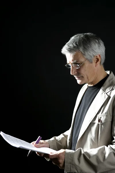 Geschäftsmann liest bei der Arbeit, ältere graue Haare — Stockfoto