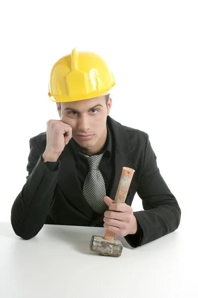 Architect with hammer and helmet, sad mood — Stock Photo, Image