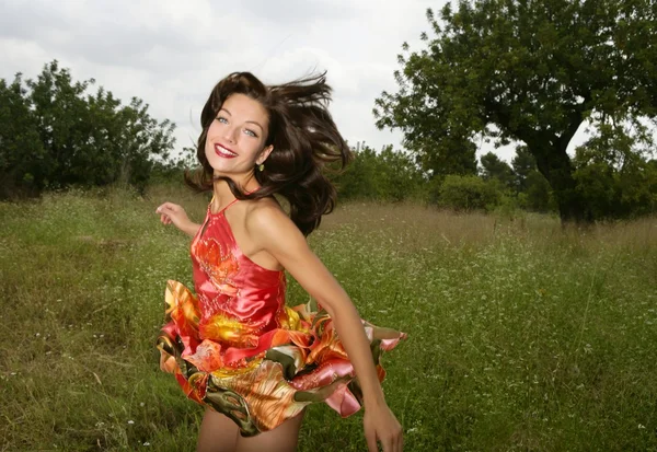 Woman haute couture jumping on the forest — Stock Photo, Image