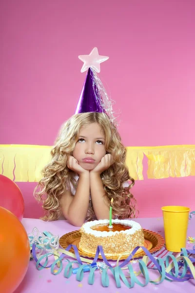 Bored little blond girl birthday party with candle cake — Stock Photo, Image