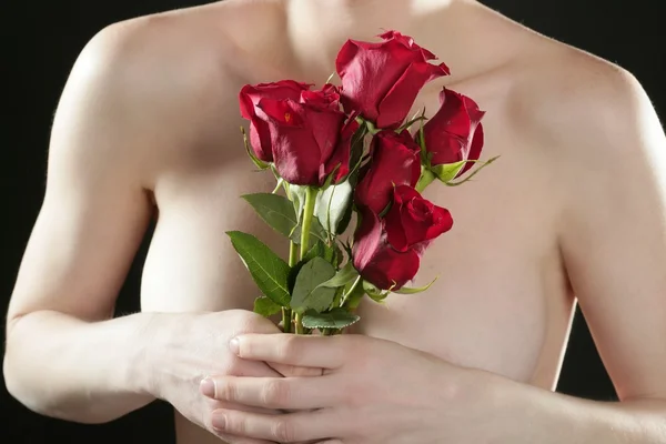Romantic nude woman holding red roses — Stock Photo, Image