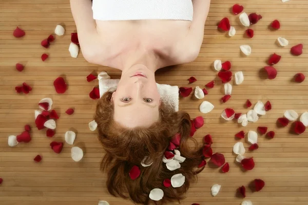 Redhead beautiful woman, rose petals on hair — Stok fotoğraf