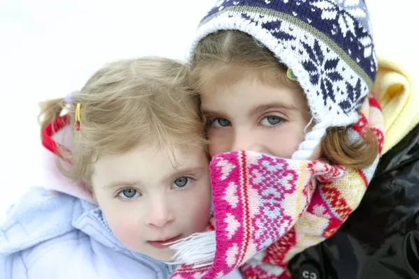 Two little girls with wooden winter hat — Stock Photo, Image