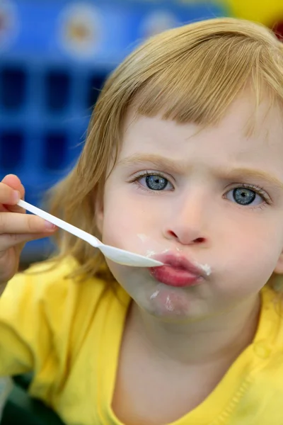 Ξανθό κοριτσάκι που τρώει και χειρονομίες — Φωτογραφία Αρχείου
