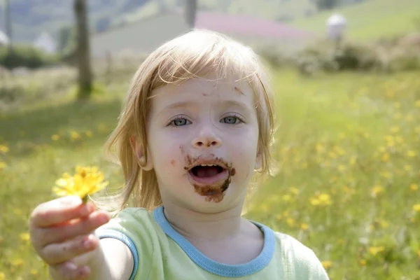 Adorable little girl eating chocolate — Stock Photo, Image